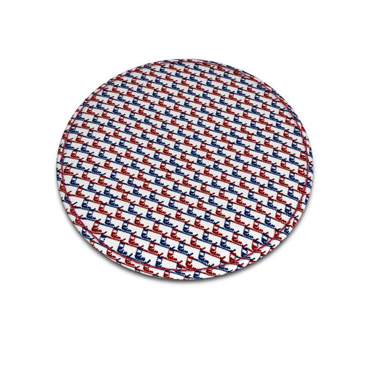 A round leather coaster with red and blue ski boot pattern that's similar to a traditional houndstooth pattern.