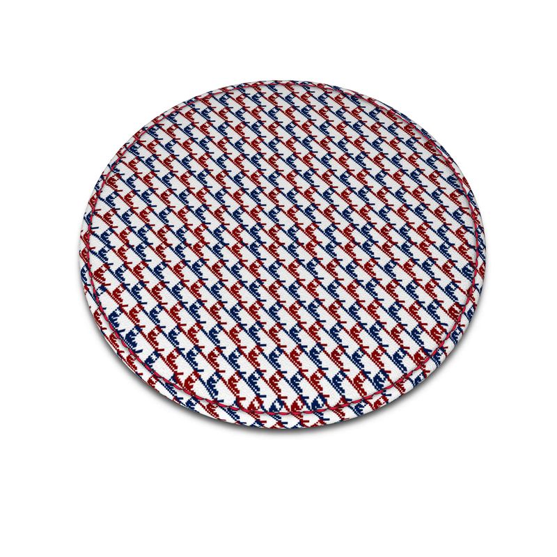 A round leather coaster with a ski boot pattern in red, white and blue.