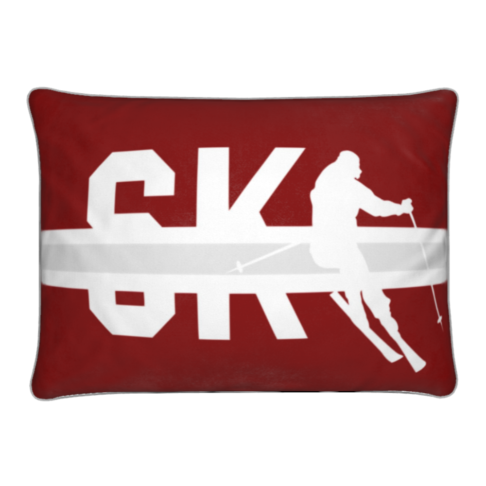 Red Cushion with silhouette of a skier and the word SKI.
