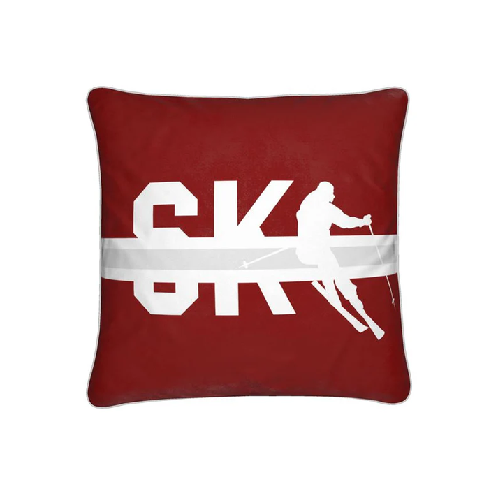A red cushion with the word SKI and a silhouette of a skier.