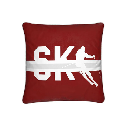 A red cushion with the word SKI and a silhouette of a skier.