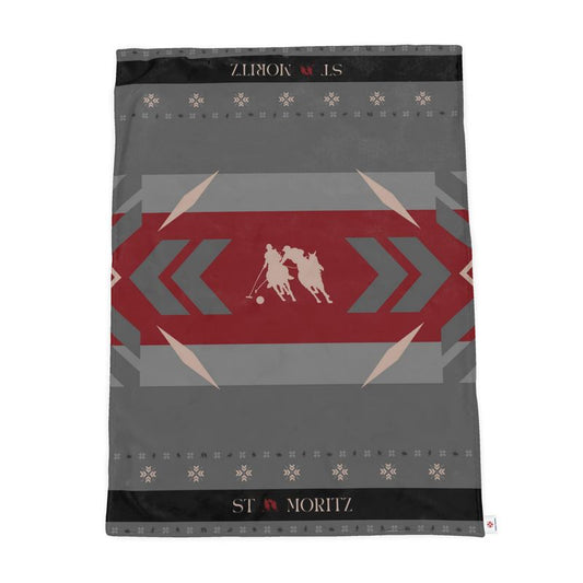 A black, grey and red, throw with snow polo players in the centre.