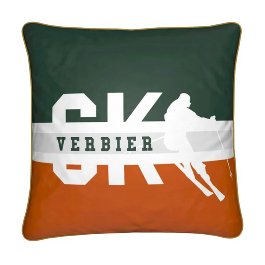 Green, gold square cushion with SKI written in white silhouette with the word SKI and Verbier.